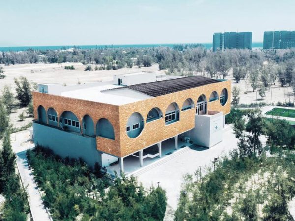 circular-shaped-windows-accenturate-the-brick-facade-of-this-library-in-vietnam-has-architecture-hna-architects